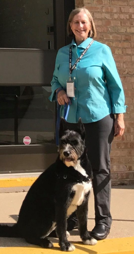 Tricia Sutton standing with her dog Elsa.